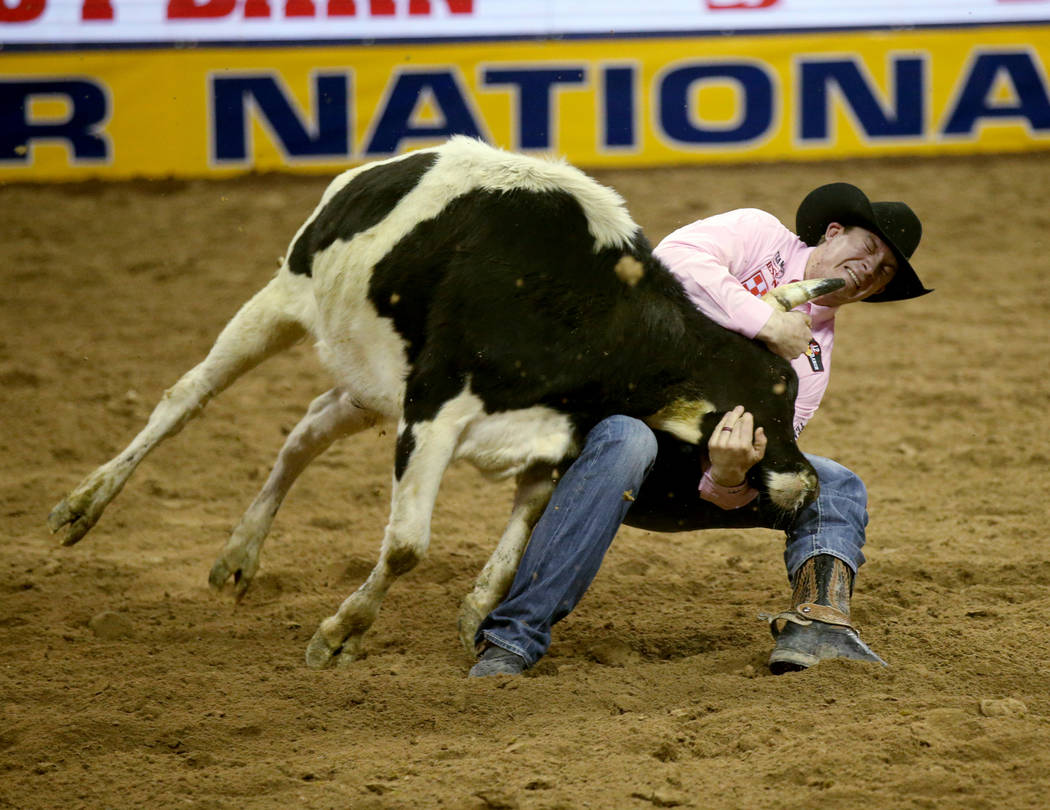 Ty Erickson of Helena, Mont. competes in Steer Wrestling during Bareback Riding in the fifth go ...