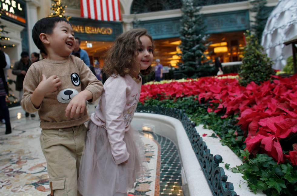 Alden Sutheno, 3, and Tala Taherzadeh, 3, wait for the toy train at the Bellagio Conservatory & ...