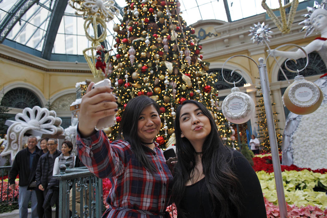 Shu Pan, left, and Michelle Leon take a selfie at the Bellagio Conservatory & Botanical Garden ...