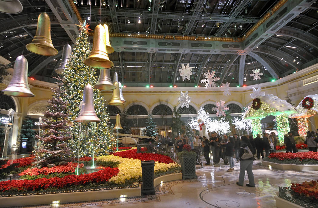Visitors walk through the 2011 Winter Holiday Exhibit at the Bellagio Conservatory & Botanical ...