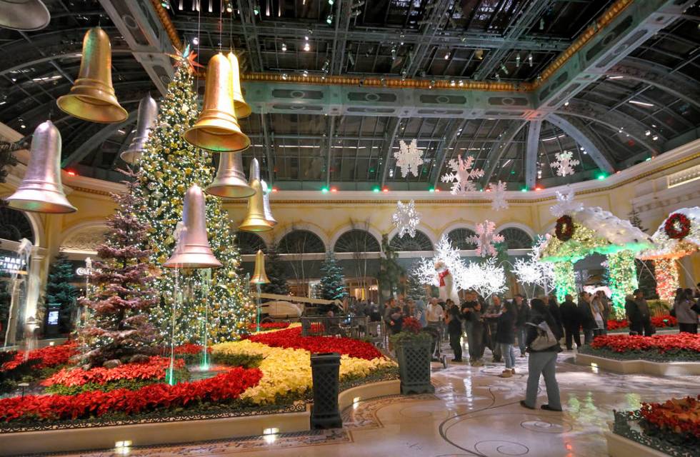 Visitors walk through the 2011 Winter Holiday Exhibit at the Bellagio Conservatory & Botanical ...