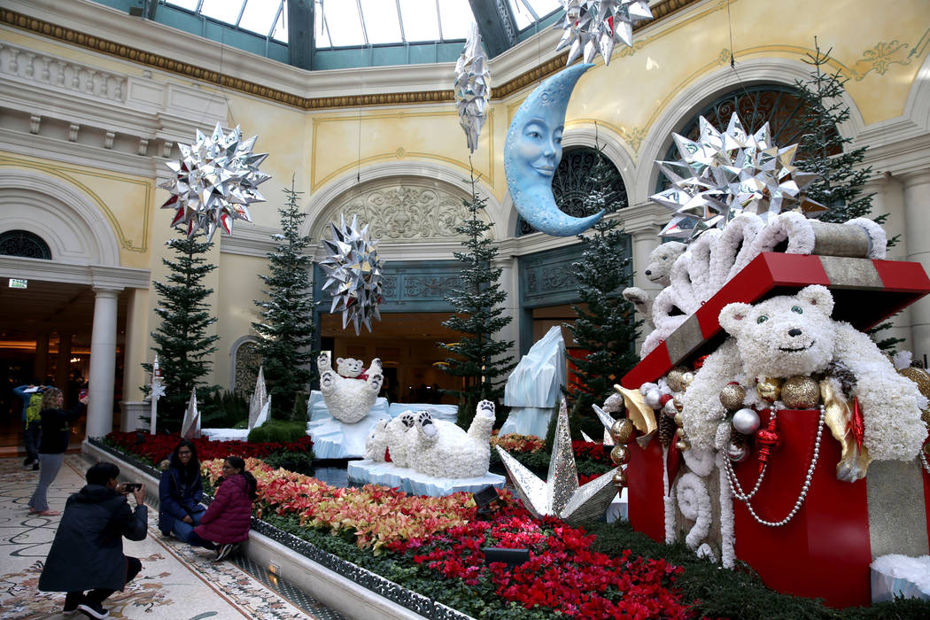 Guests check out the Majestic Holiday Magic at the Bellagio Conservatory & Botanical Garden in ...