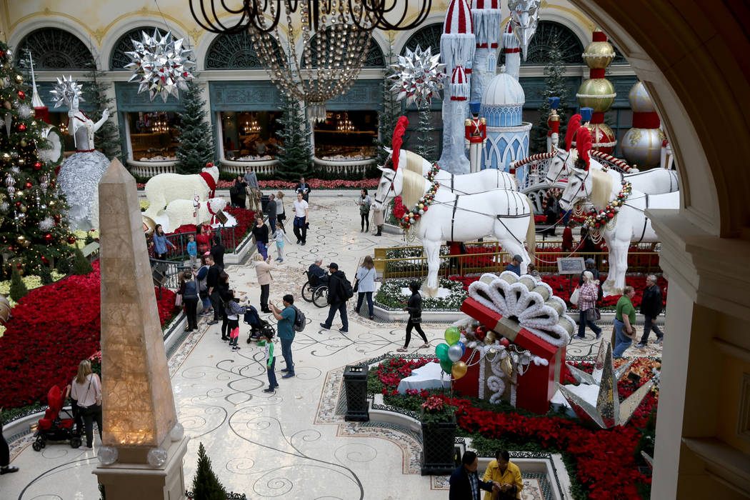 Guests check out the Majestic Holiday Magic at the Bellagio Conservatory & Botanical Garden Dec ...