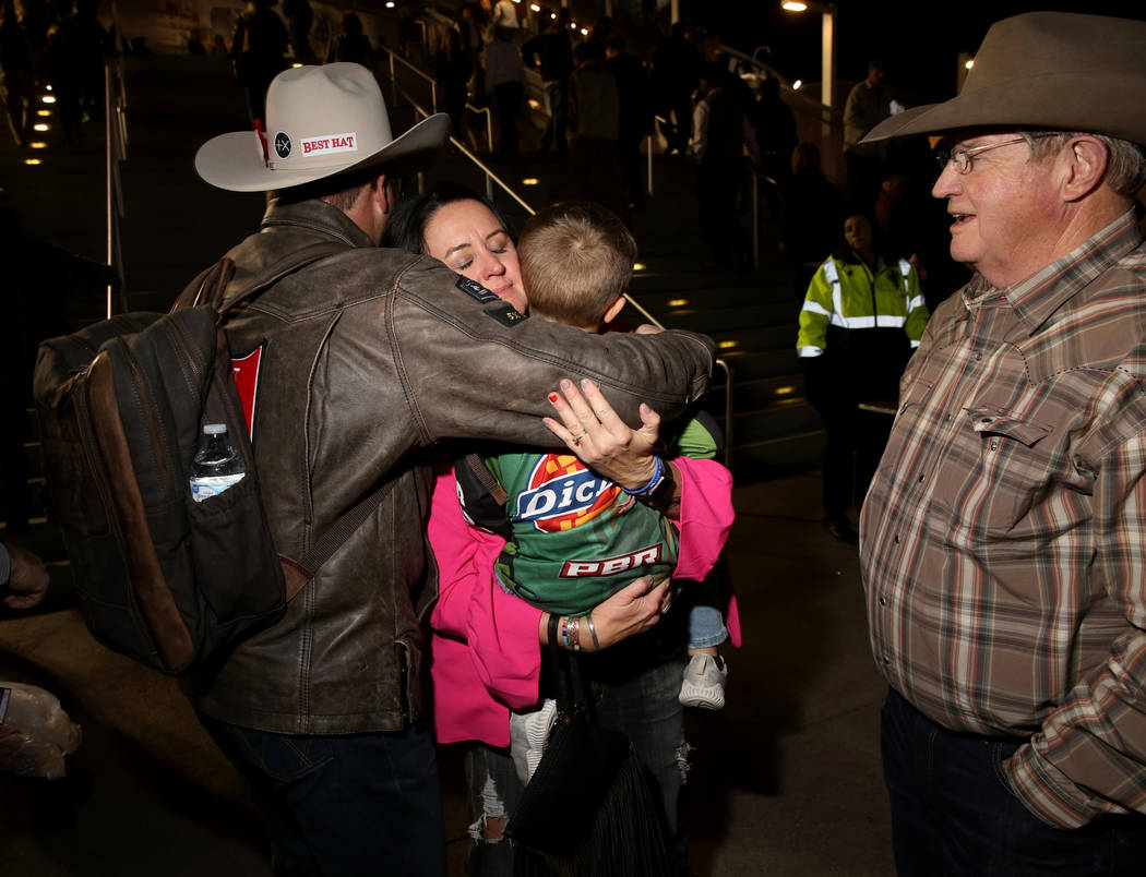 Missi Henderson, 43, of Winfield, Kan., gets a hug from National Finals Rodeo roper Coleman Pro ...