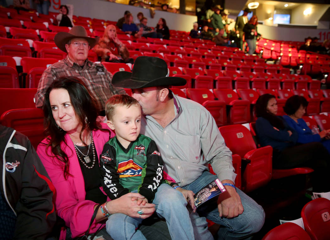 Missi Henderson, 43, of Winfield, Kan., takes her seats with son Murphy, 4, and husband Shane, ...