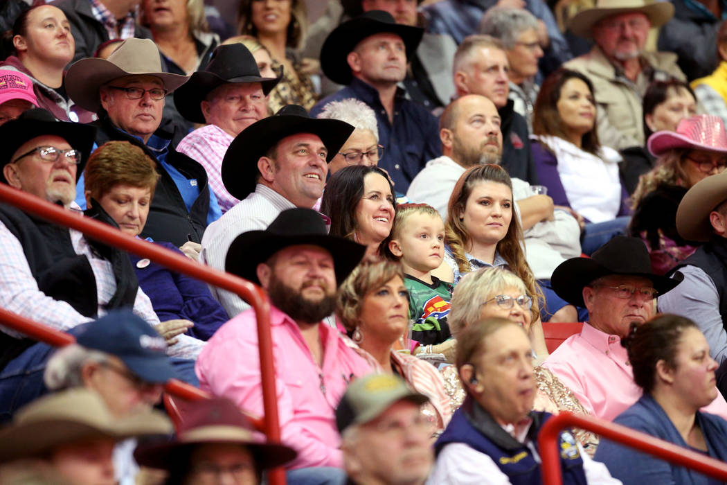 Missi Henderson, 43, of Winfield, Kan., watches the National Finals Rodeo with son Murphy, 4, a ...