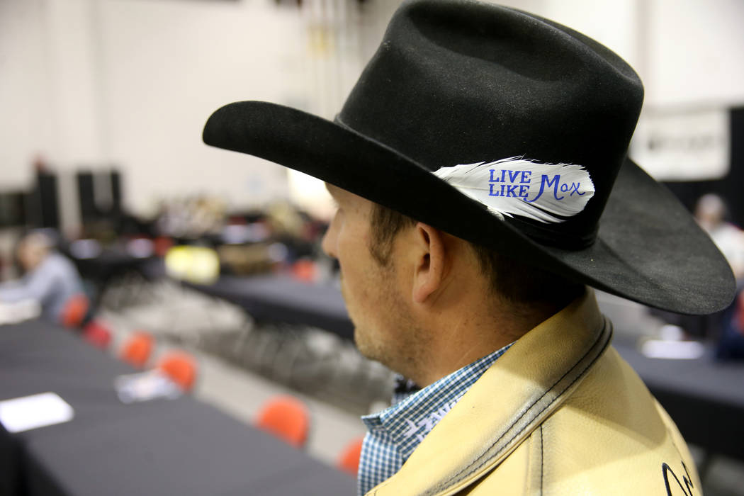 Steer wrestler Riley Duvall dons a "Live Like Max" white before the sixth go-round of ...