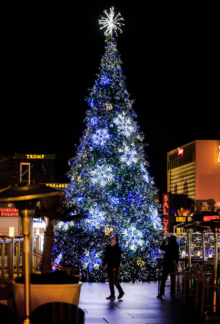 The giant Christmas tree is a visual backdrop about the ice rink at The Cosmopolitan of Las Veg ...
