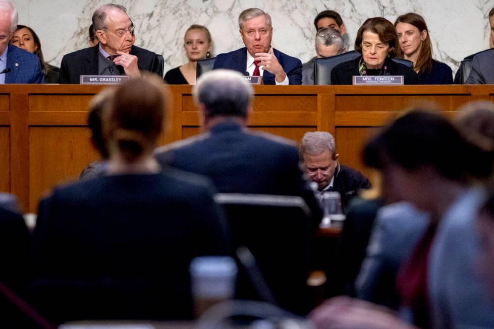 Chairman Lindsey Graham, R-S.C., center, accompanied by Sen. Chuck Grassley, R-Iowa, left, and ...