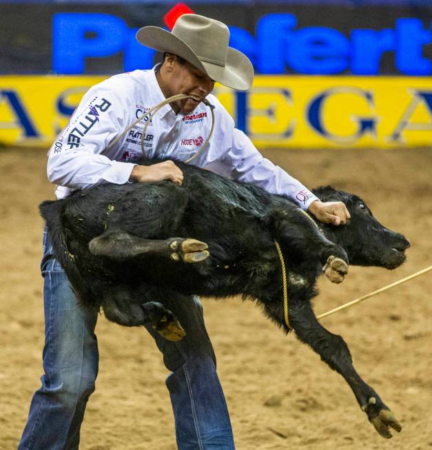 Shad Mayfield of of Clovis, N.M., tosses a roped calf in Tie-Down Roping during the sixth go ro ...