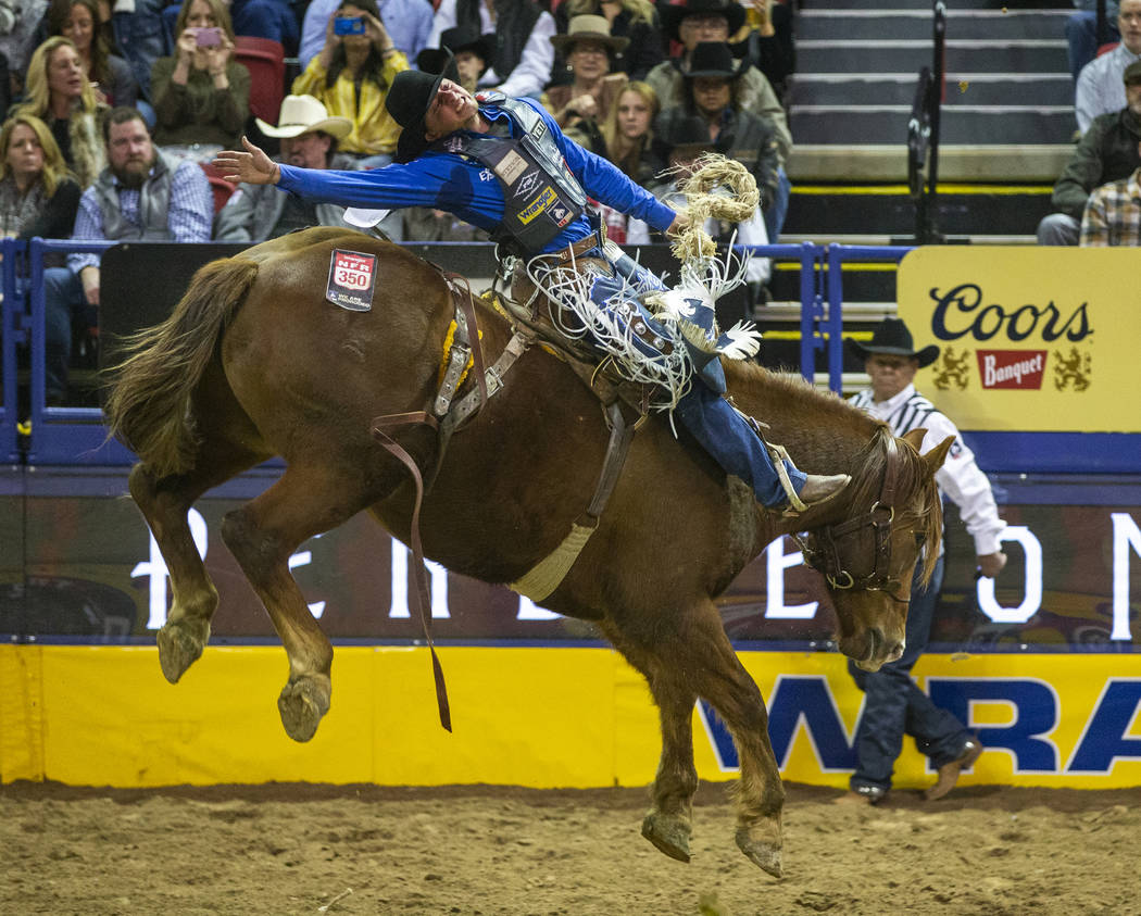Dawson Hay of Wildwood, Alberta, leans back on Sue City Sue during Saddle Bronc Riding for a fi ...