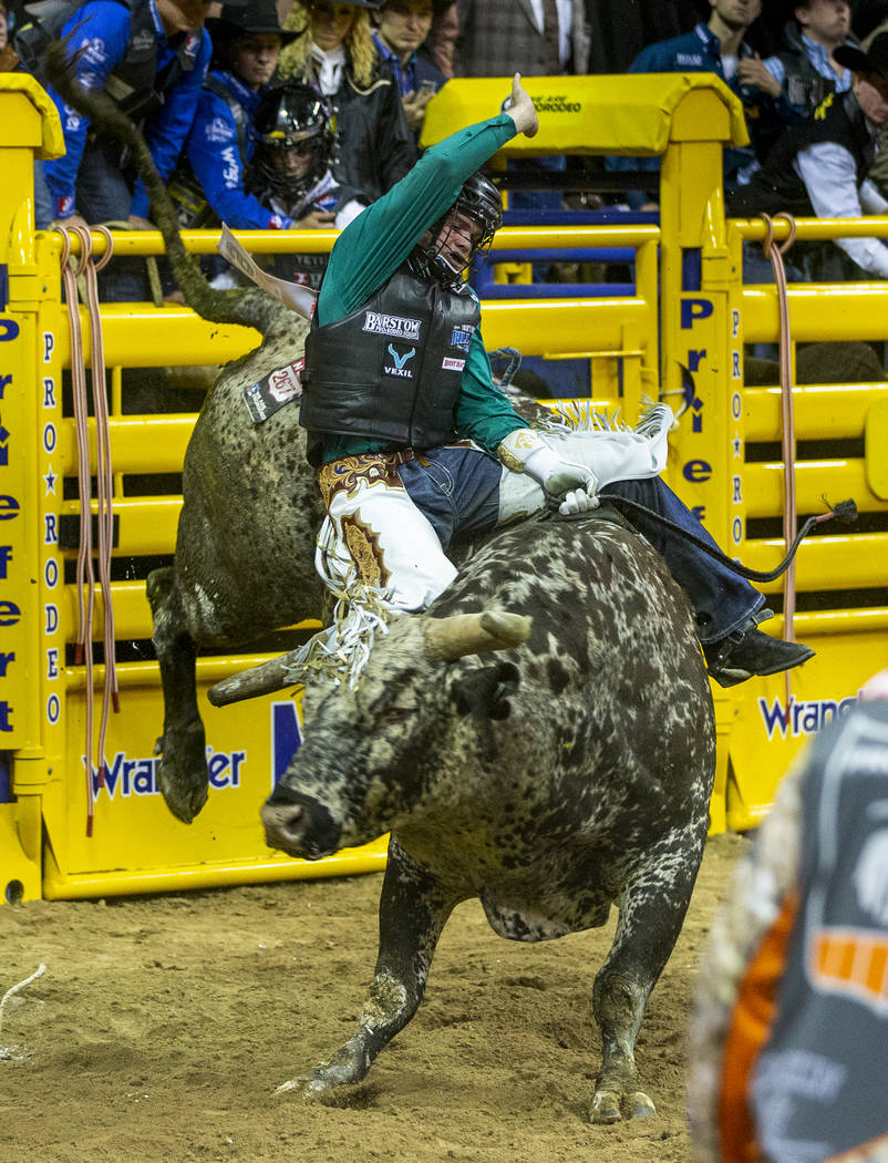 Boudreaux Campbell of Crockett, Texas, rides Priefert's Tequila Worm in Bull Riding to a first ...