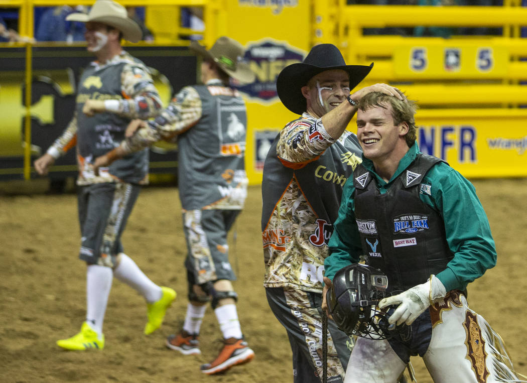 Boudreaux Campbell of Crockett, Texas, is congratulated by a bullfighter after riding Priefert' ...