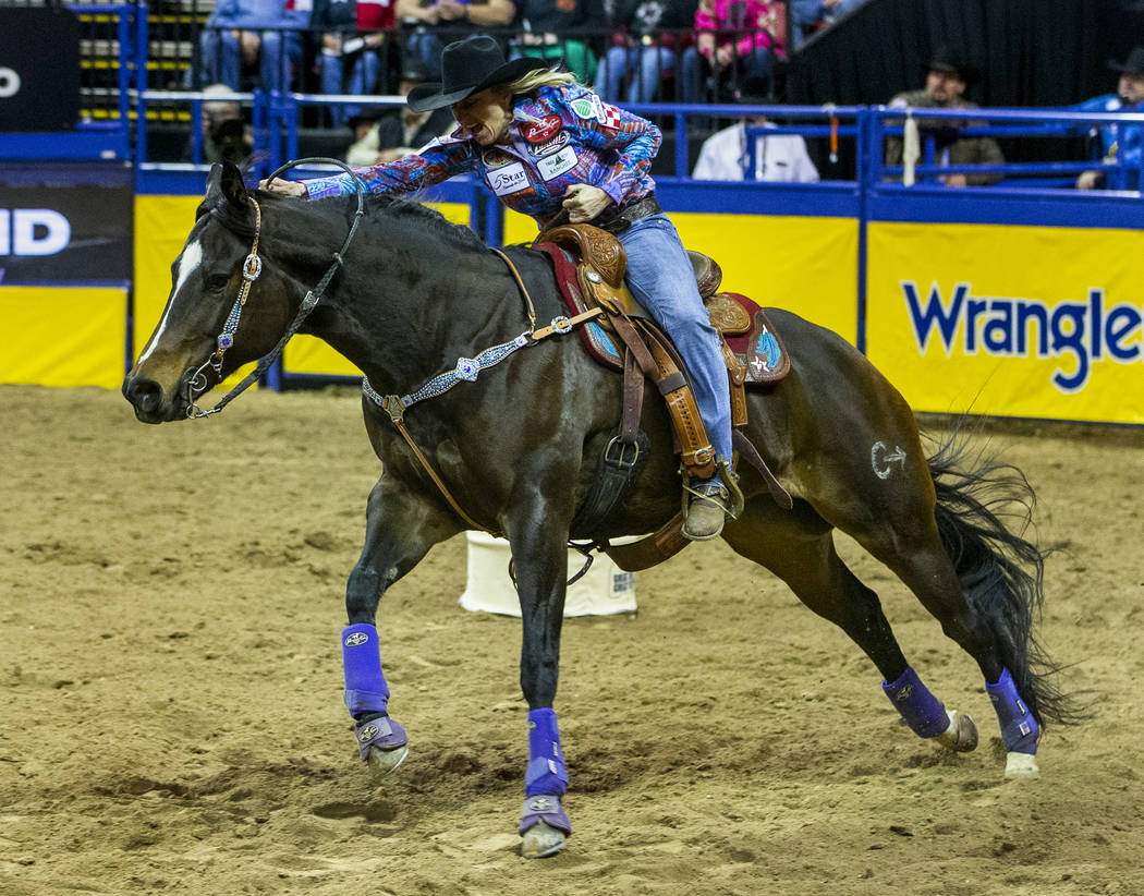 Amberleigh Moore of Salem, Ore,. heads for home in Barrel Racing for a first-place time of 13.5 ...