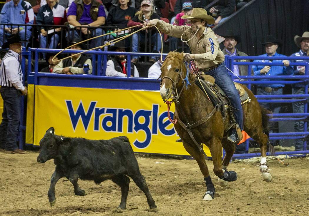 Ty Harris of San Angelo, Texas, bears down on a calf in Tie-Down Roping for a first place time ...