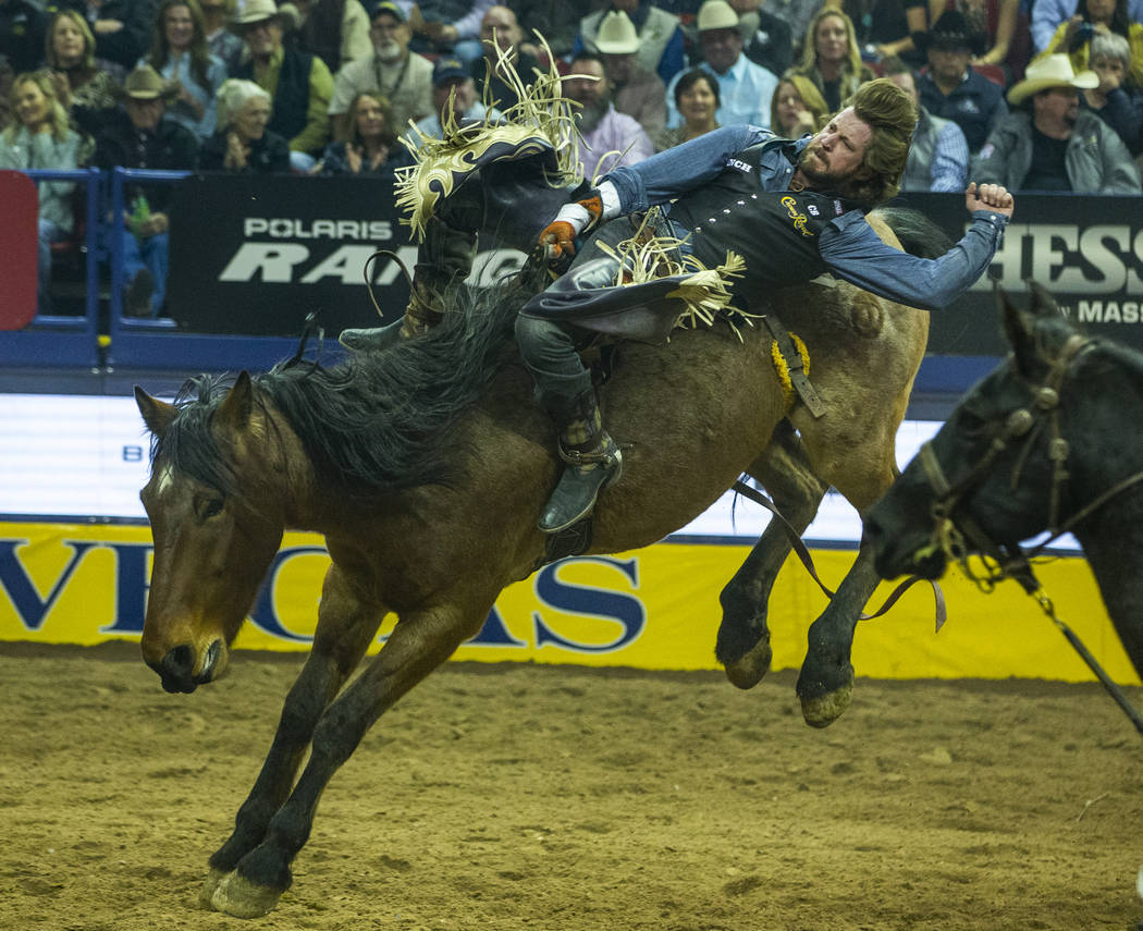 Tilden Hooper of Carthage, Texas, rides Ain't No Angel in Bareback Riding to a first-place tie ...