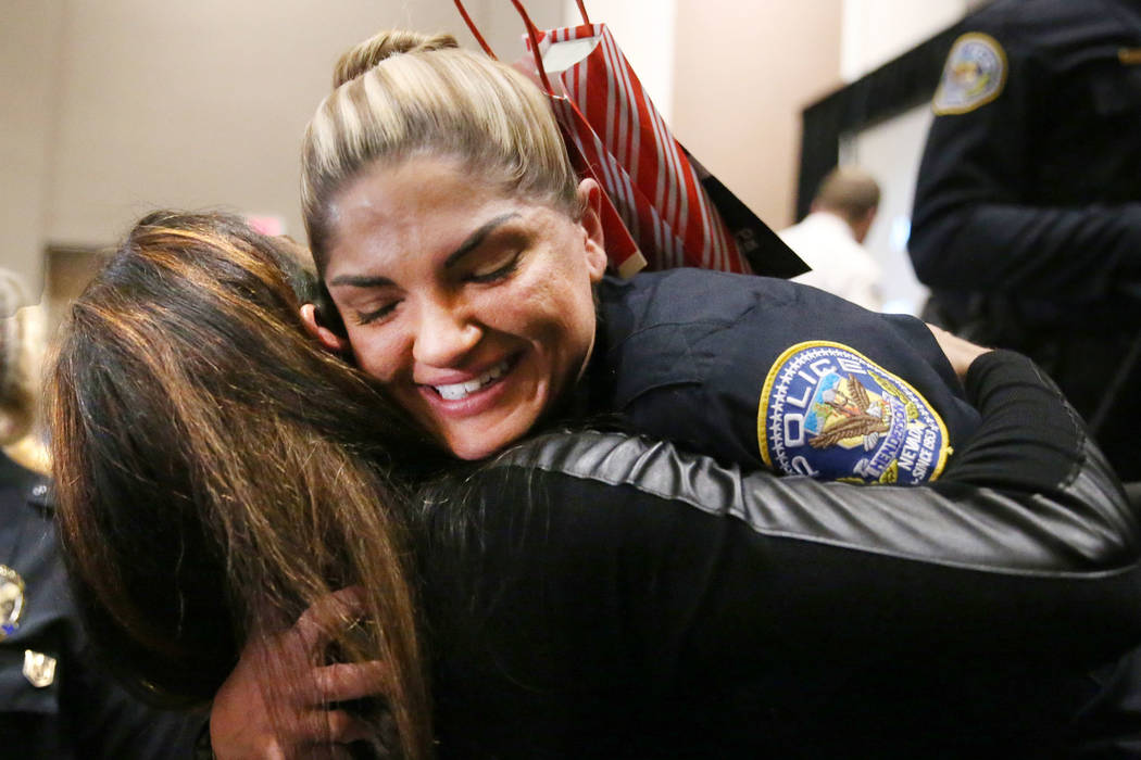 Samantha Nameth is embraces by her friend Stephanie Leigh following her graduation ceremony fro ...