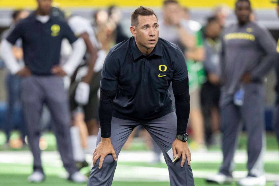 ARLINGTON, TX - AUGUST 31: Oregon Ducks Assistant Head Coach Marcus Arroyo looks on during the ...