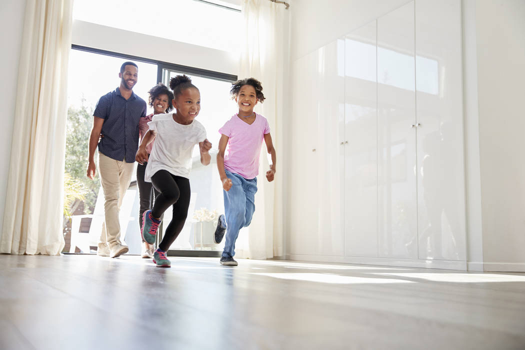 Excited Family Exploring New Home On Moving Day