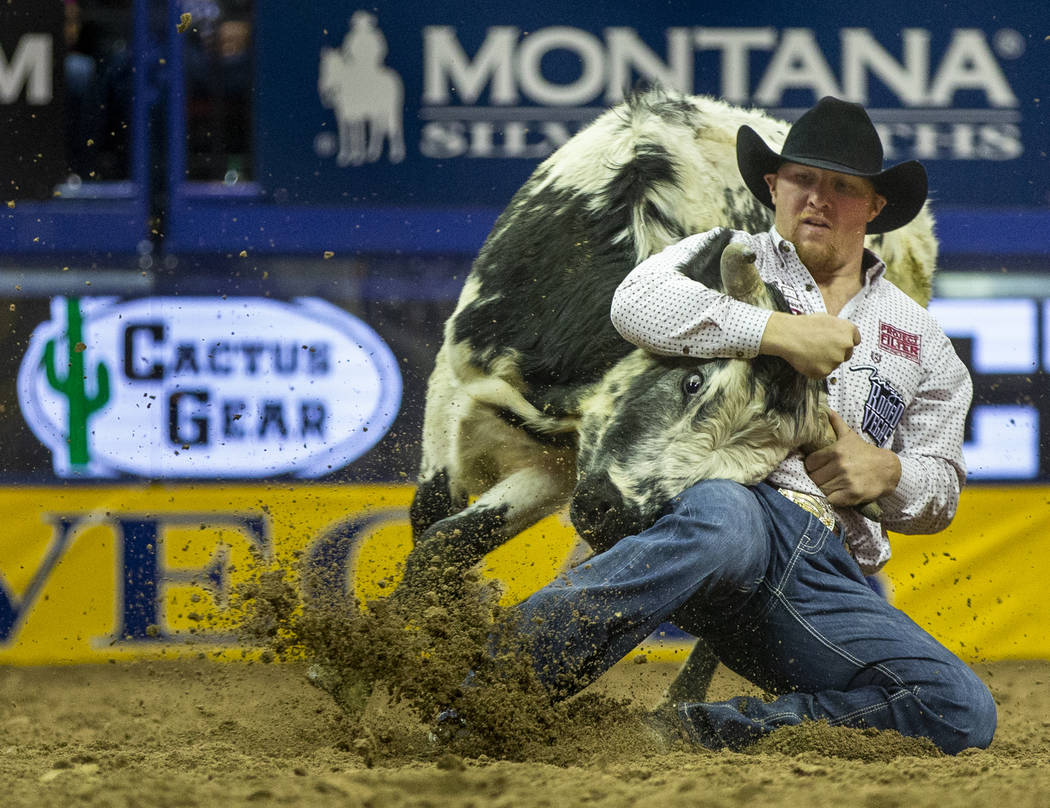 Stetson Jorgensen of Blackfoot, Idaho, turns a steer during a first place time of 3.40 seconds ...