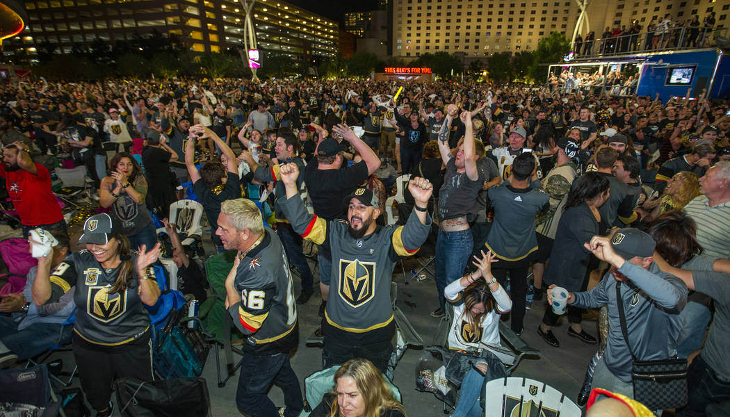 Golden Knights fan Hugo Alcala celebrates with others during a watch party at Toshiba Plaza in ...