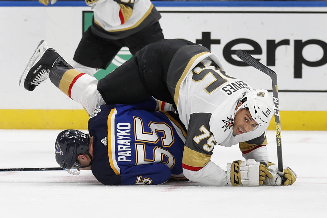 Vegas Golden Knights' Ryan Reaves (75) falls over St. Louis Blues' Colton Parayko (55) during t ...