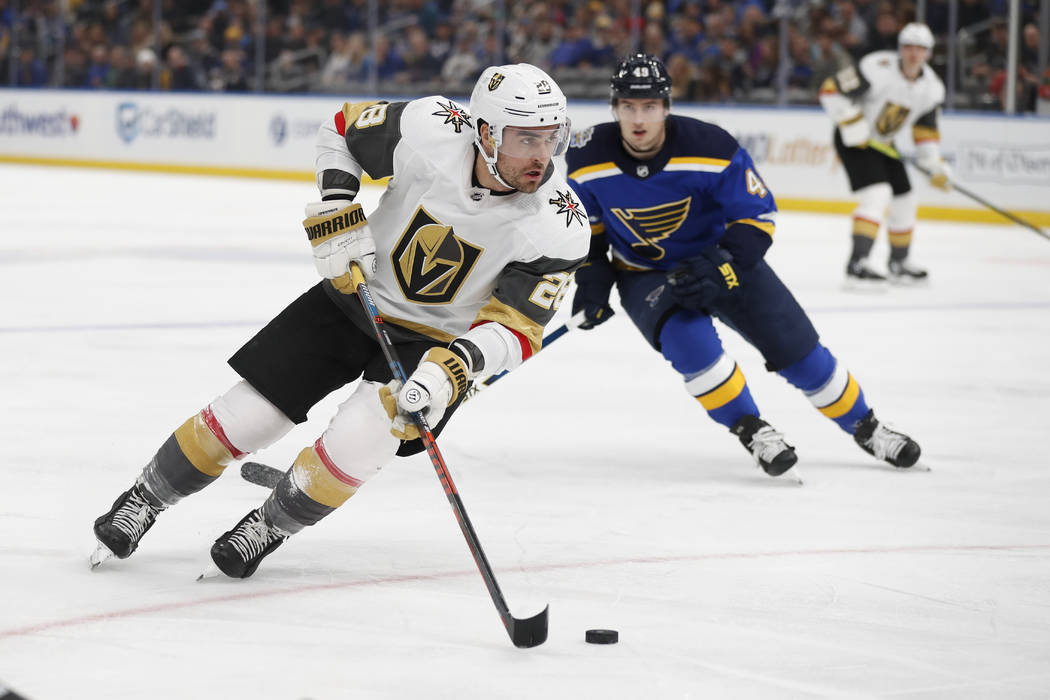 Vegas Golden Knights' William Carrier (28) handles the puck as St. Louis Blues' Ivan Barbashev ...
