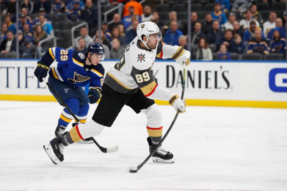 Vegas Golden Knights' Alex Tuch (89) shoots as St. Louis Blues' Vince Dunn (29) defends during ...