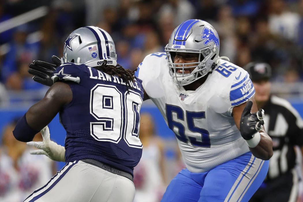 Detroit Lions offensive tackle Tyrell Crosby (65) blocks Dallas Cowboys defensive end Demarcus ...