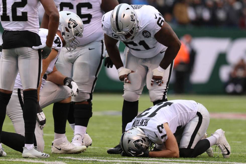 Oakland Raiders wide receiver Hunter Renfrow (13) remains on the field after colliding with a N ...