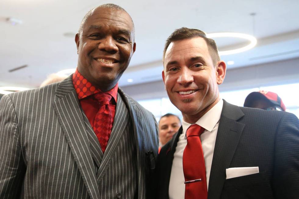 New UNLV football head coach Marcus Arroyo, left, and former UNLV star Randall Cunningham, pose ...