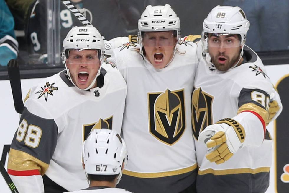 Golden Knights center Cody Eakin (21) celebrates with teammates Nate Schmidt (88), Alex Tuch (8 ...