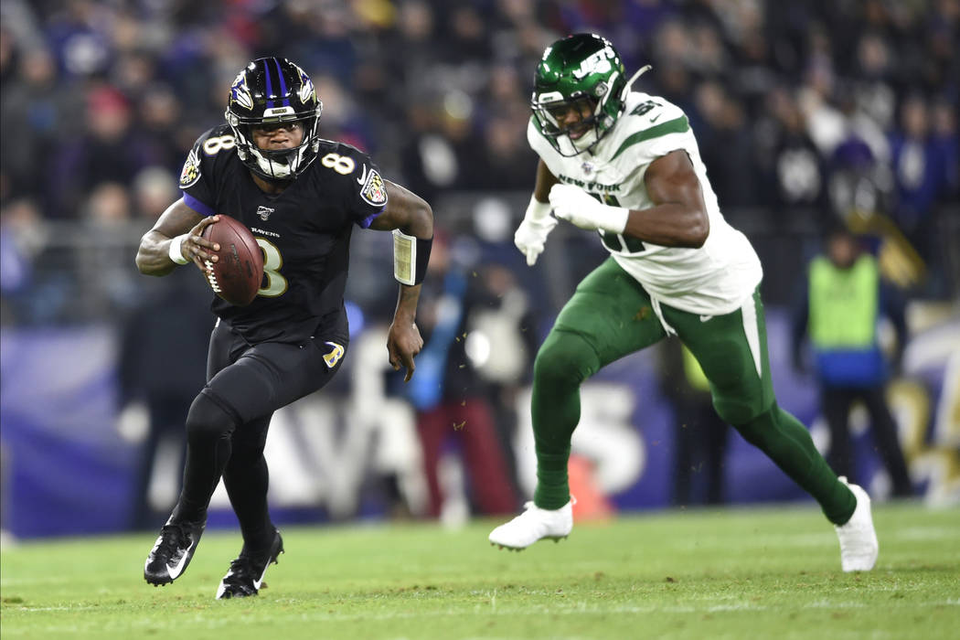 Baltimore Ravens quarterback Lamar Jackson (8) runs with the ball as New York Jets outside line ...