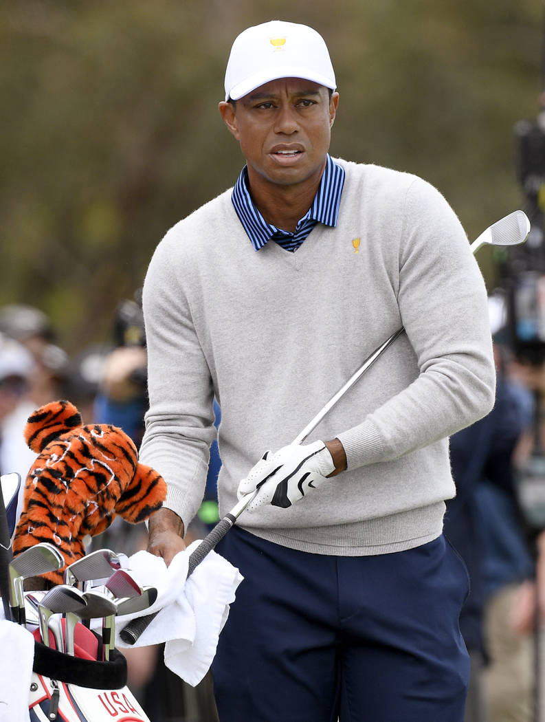 U.S. team player and captain Tiger Woods prepares to make shot on the 16th fairway in their fou ...