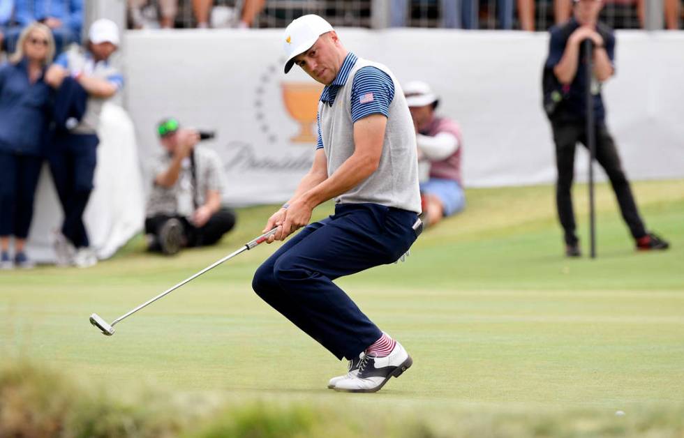 U.S. team player Justin Thomas crouches as he misses a putt on the 16th green in their foursome ...