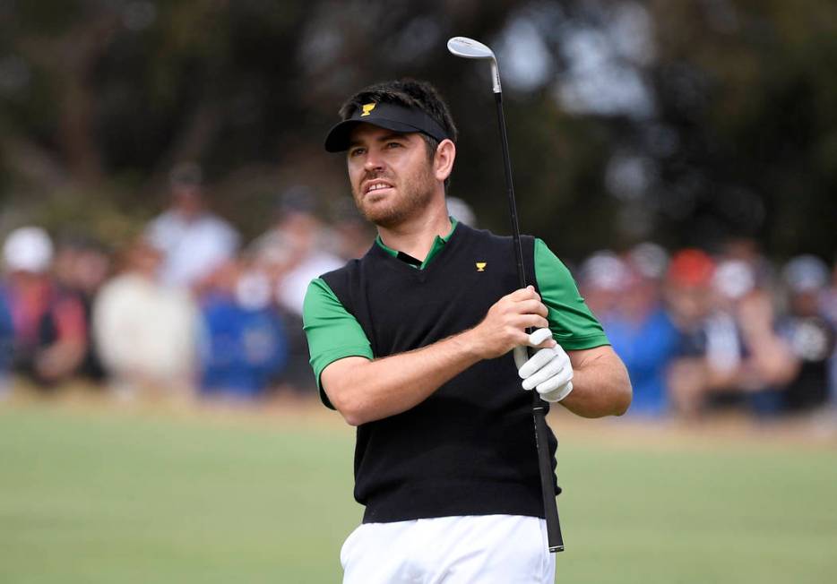 International team player Louis Oosthuizen of South Africa watches his shot on the 1rst fairway ...