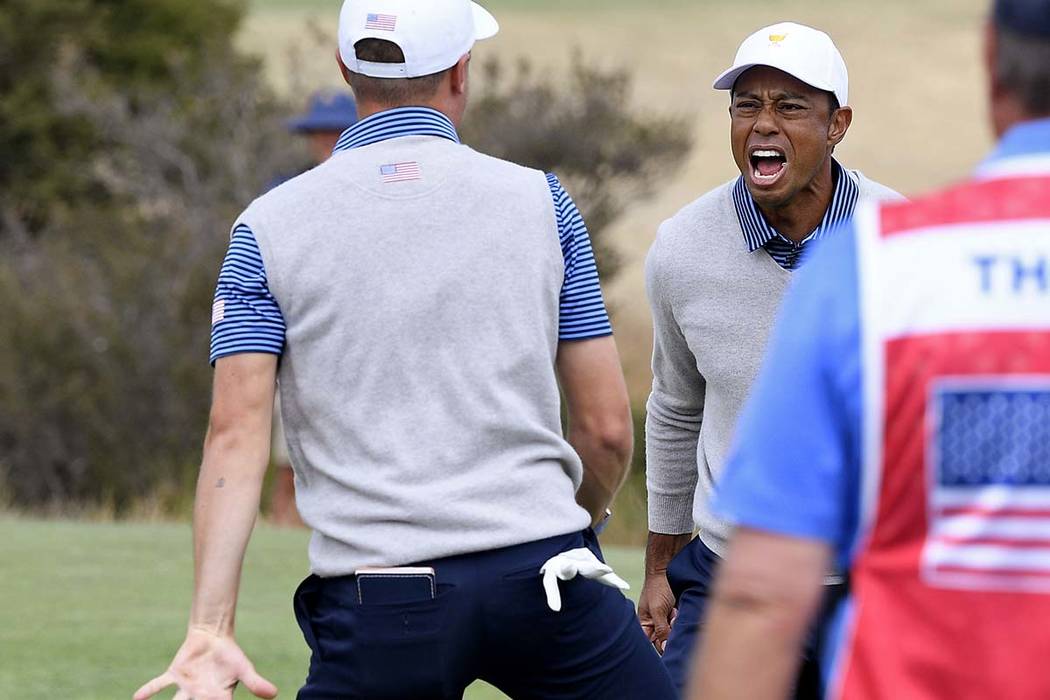 U.S. team player Justin Thomas, left, celebrates with his playing partner and captain, Tiger Wo ...