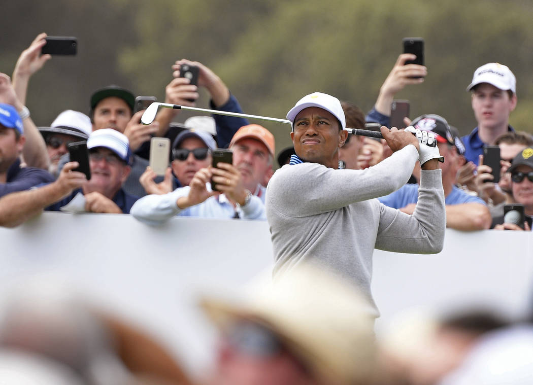 U.S. team player and captain Tiger Woods tees off on the 5th hole in their foursomes match duri ...