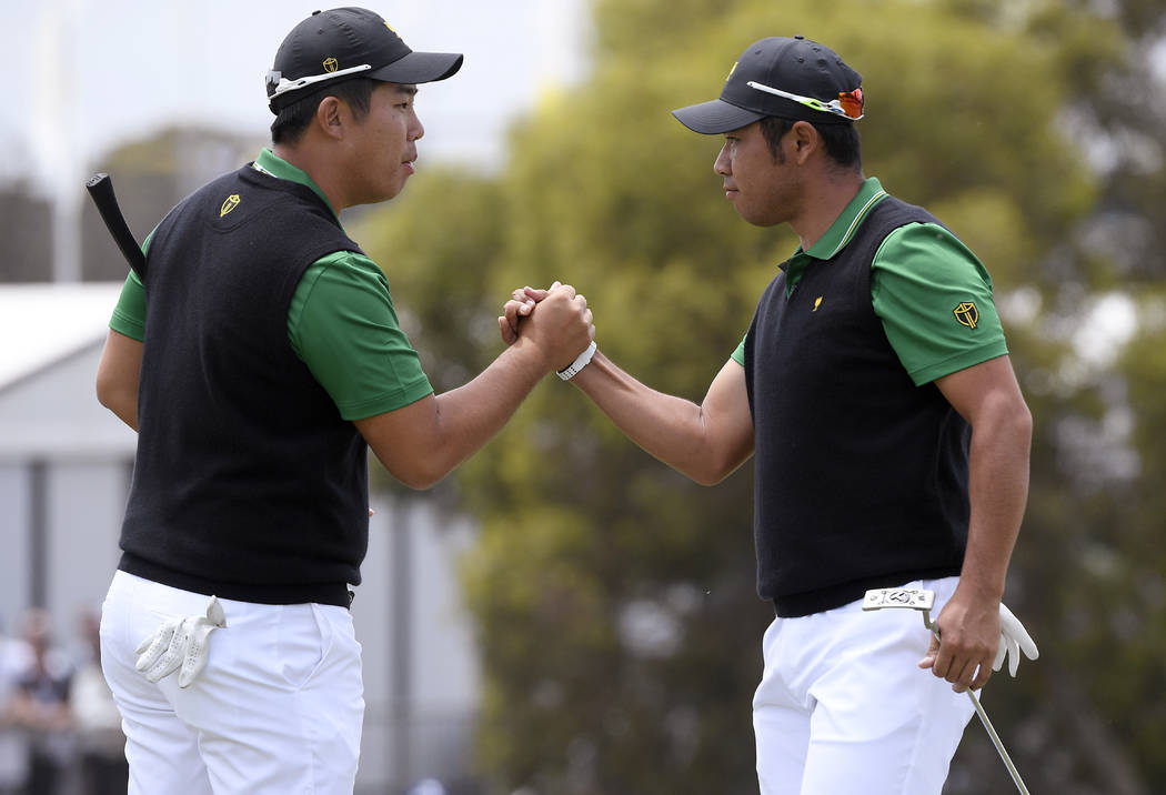 International team player Byeong Hun An, of South Korea, left, and playing partner Hideki Matsu ...