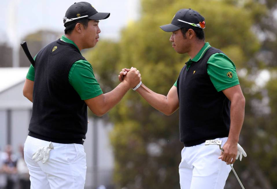 International team player Byeong Hun An, of South Korea, left, and playing partner Hideki Matsu ...