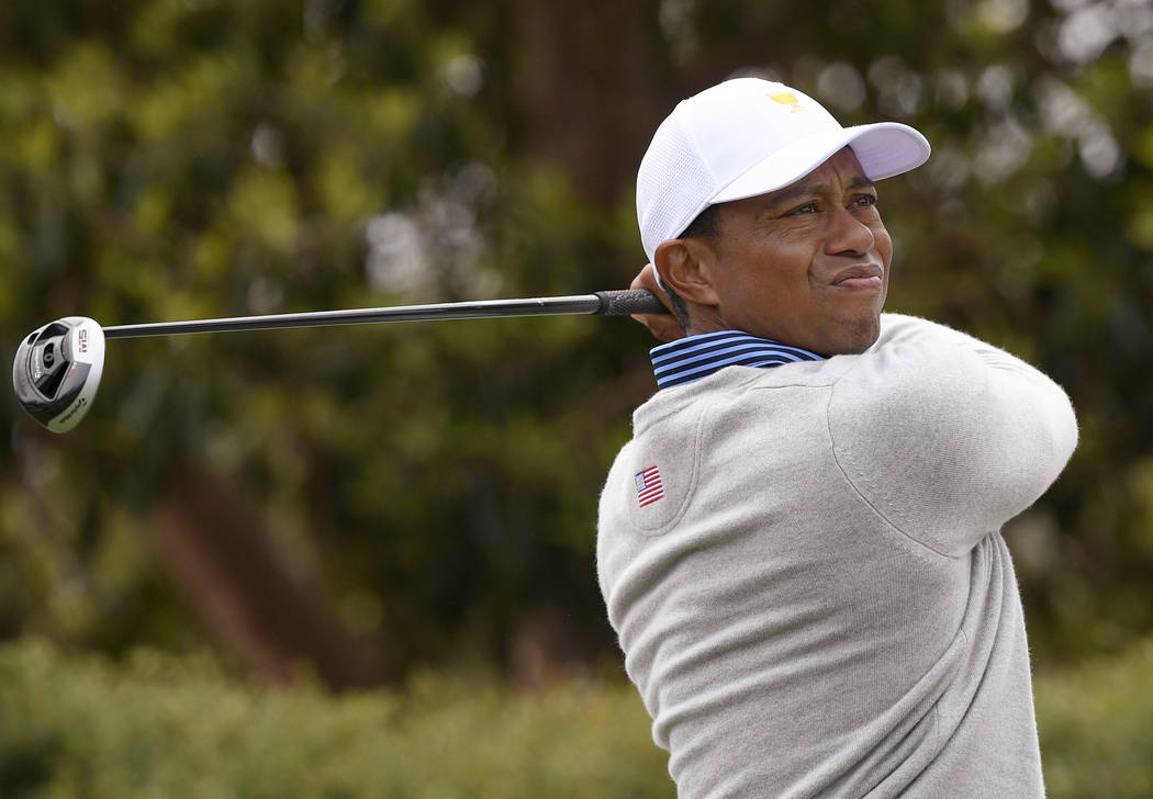 U.S. team player and captain Tiger Woods tees off on the 9th hole in their foursomes match duri ...