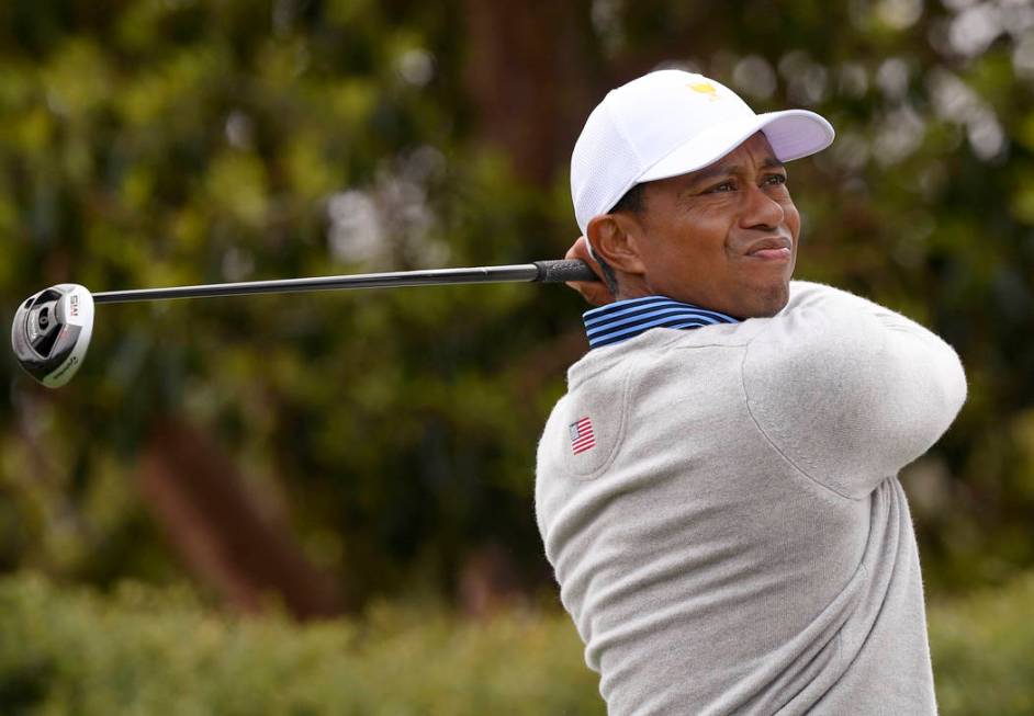 U.S. team player and captain Tiger Woods tees off on the 9th hole in their foursomes match duri ...