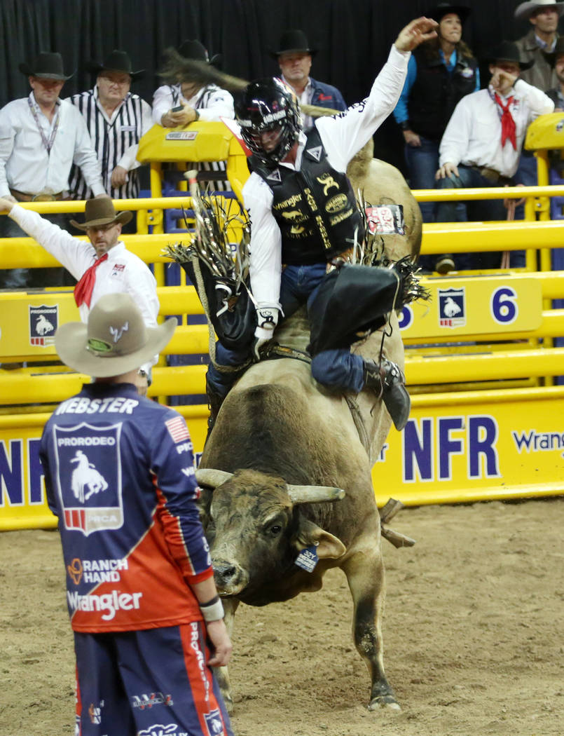 Sage Kimzey of Strong City, Okla. rides SweetPro's Bruiser during Bull Riding in the eighth go ...