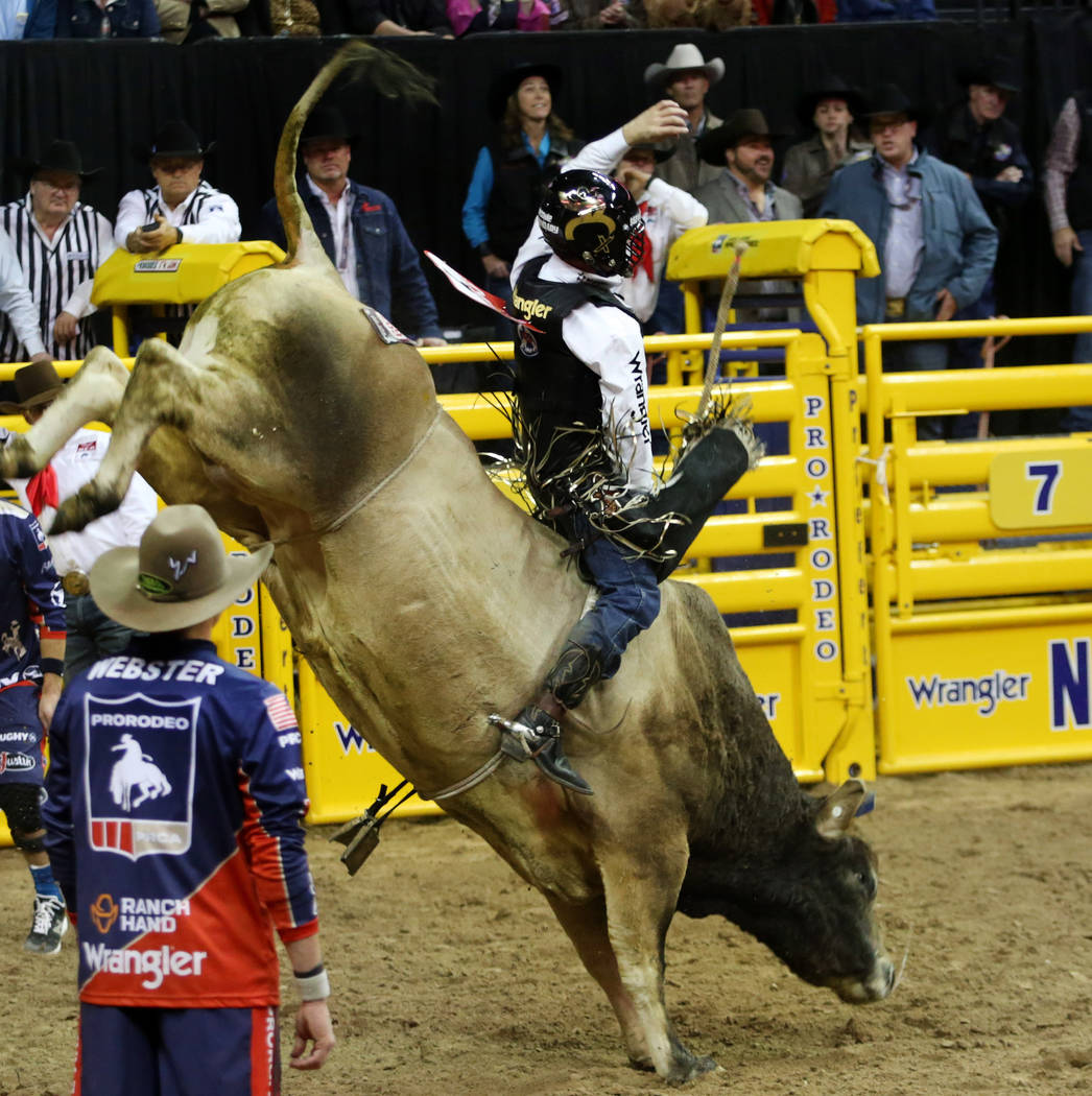Sage Kimzey of Strong City, Okla. rides SweetPro's Bruiser during Bull Riding in the eighth go ...
