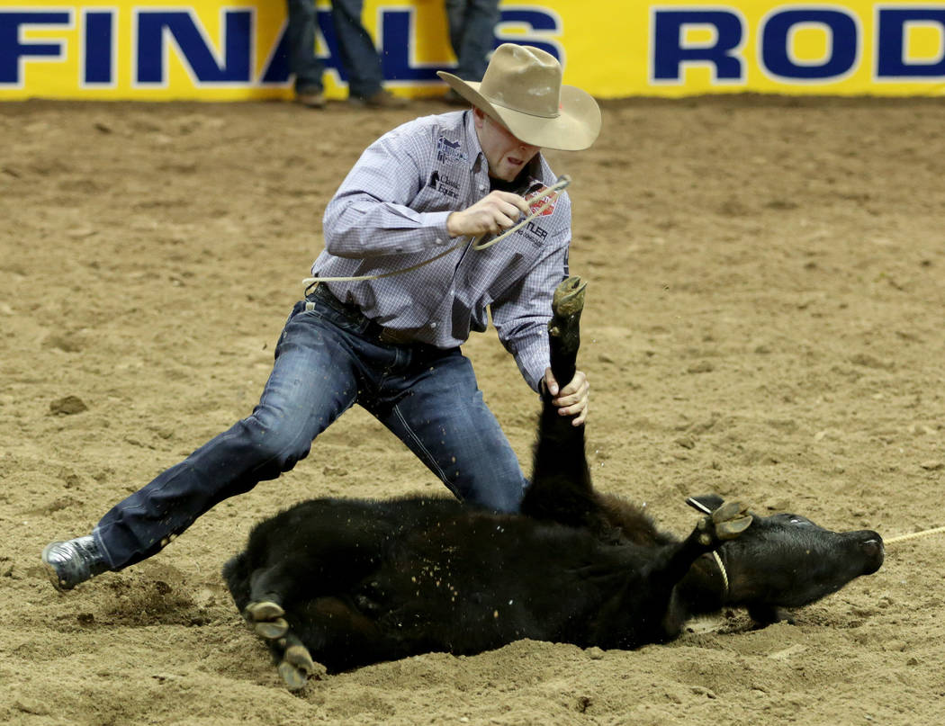 Cooper Martin of Alma, Kan. competes in Tie-down Roping in the eighth go-round of the Wrangler ...