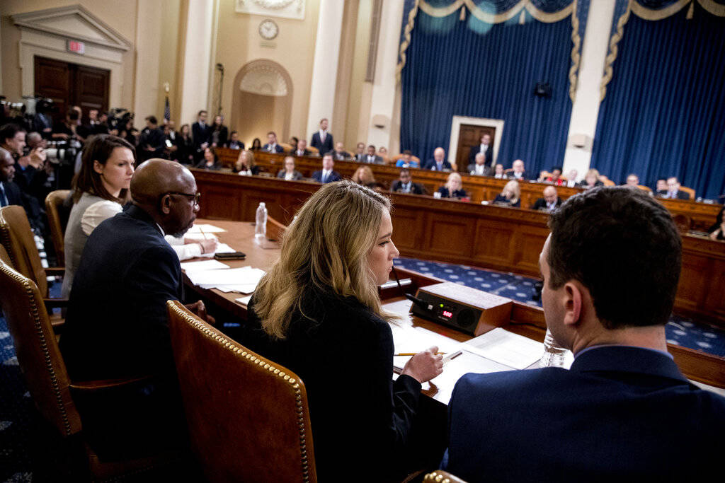 Madeline Strasser, chief clerk for the majority on the House Judiciary Committee, center, check ...