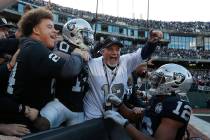 Oakland Raiders wide receiver Rico Gafford (10) celebrates with fans and wide receiver Zay Jone ...