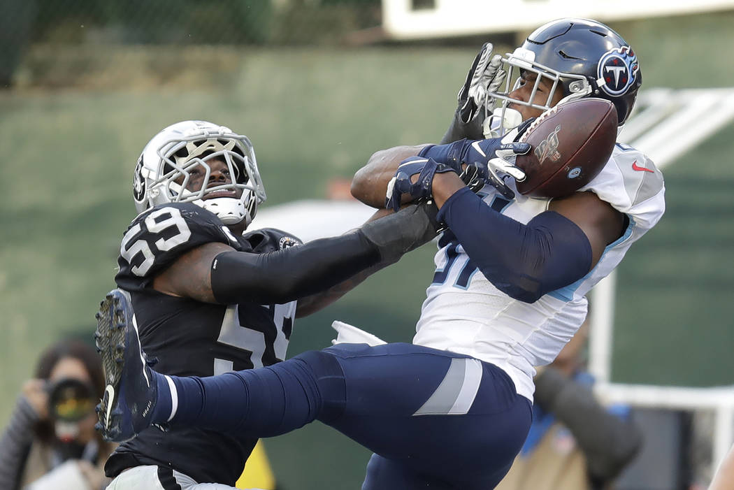 Tennessee Titans tight end Jonnu Smith, right, catches a touchdown pass against Oakland Raiders ...