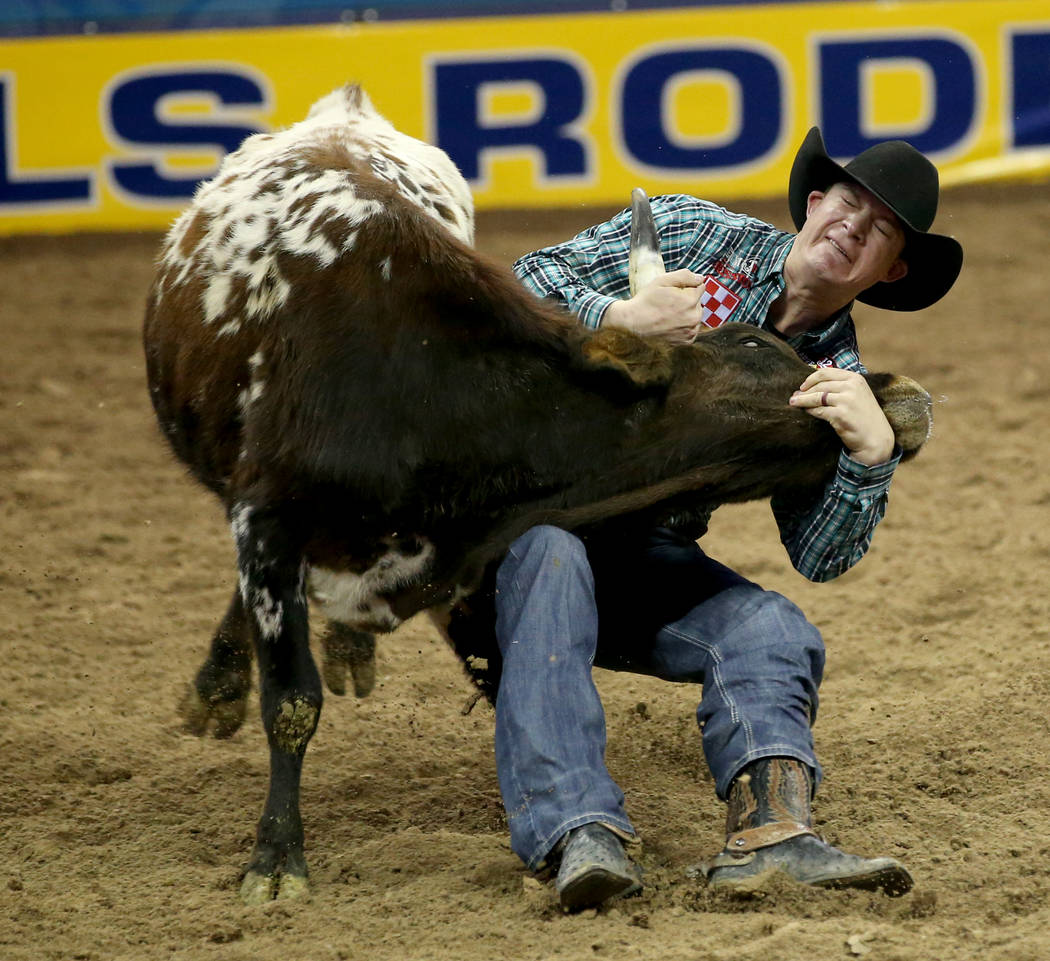 Ty Erickson of Helena, Mont. competes in Steer Wrestling during the ninth go-around of the Wran ...