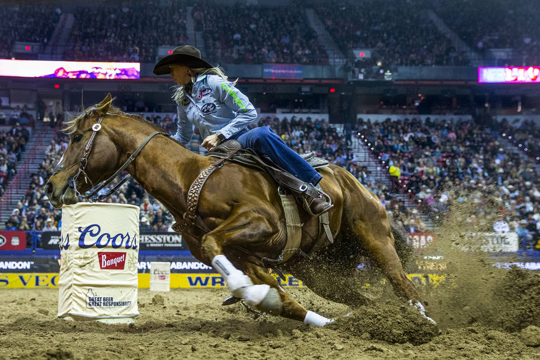 Shali Lord of Lamar, Colo., cuts around a barrel during Barrel Racing in the seventh go round o ...